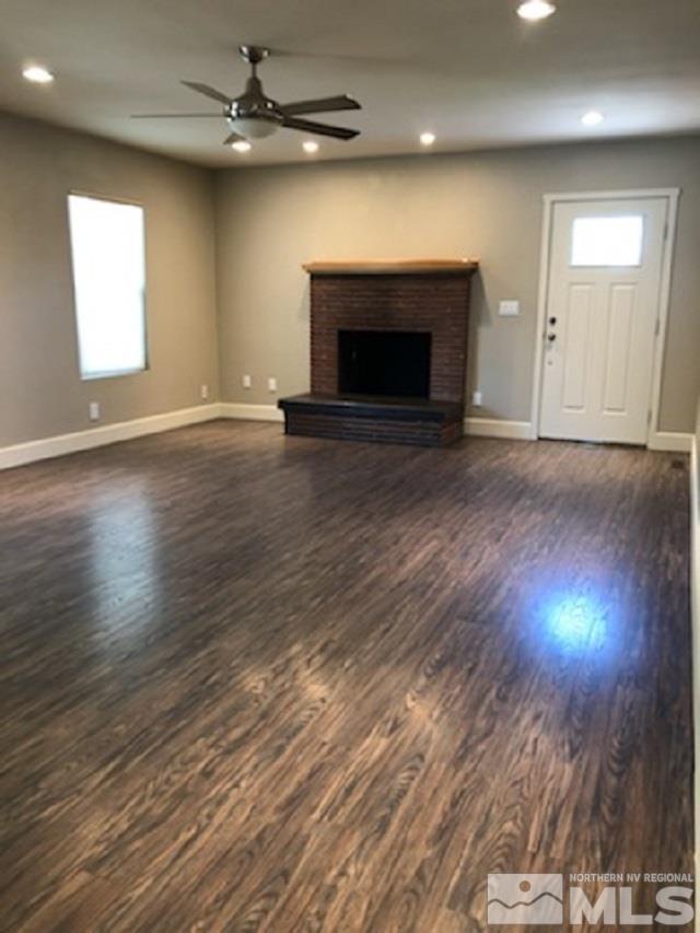 259 West Arroyo Street Reno, NV 89509 - Photo 6 of 24 an empty room with wooden floor fireplace and windows