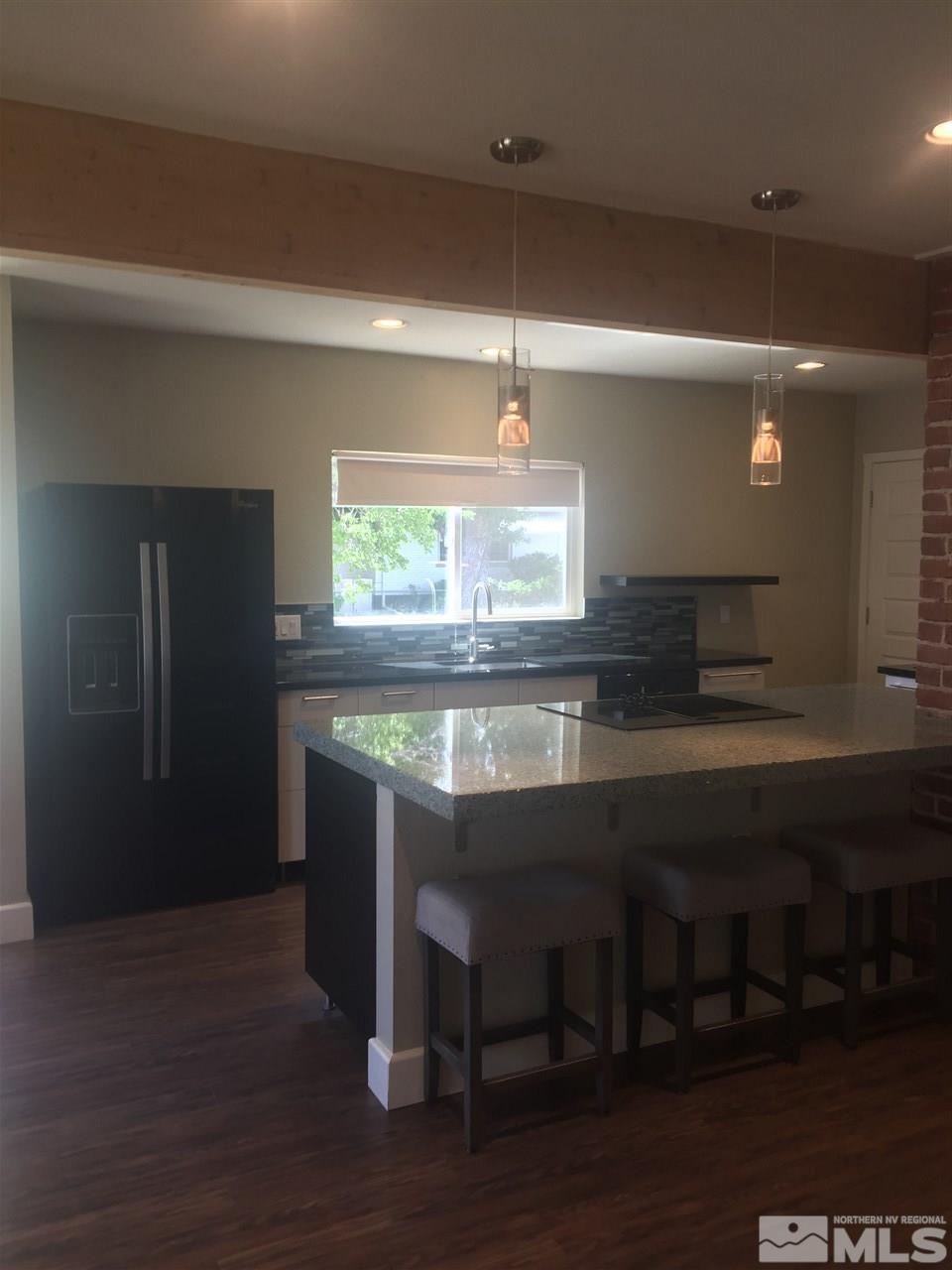 259 West Arroyo Street Reno, NV 89509 - Photo 8 of 24 a kitchen with granite countertop a stove and a refrigerator