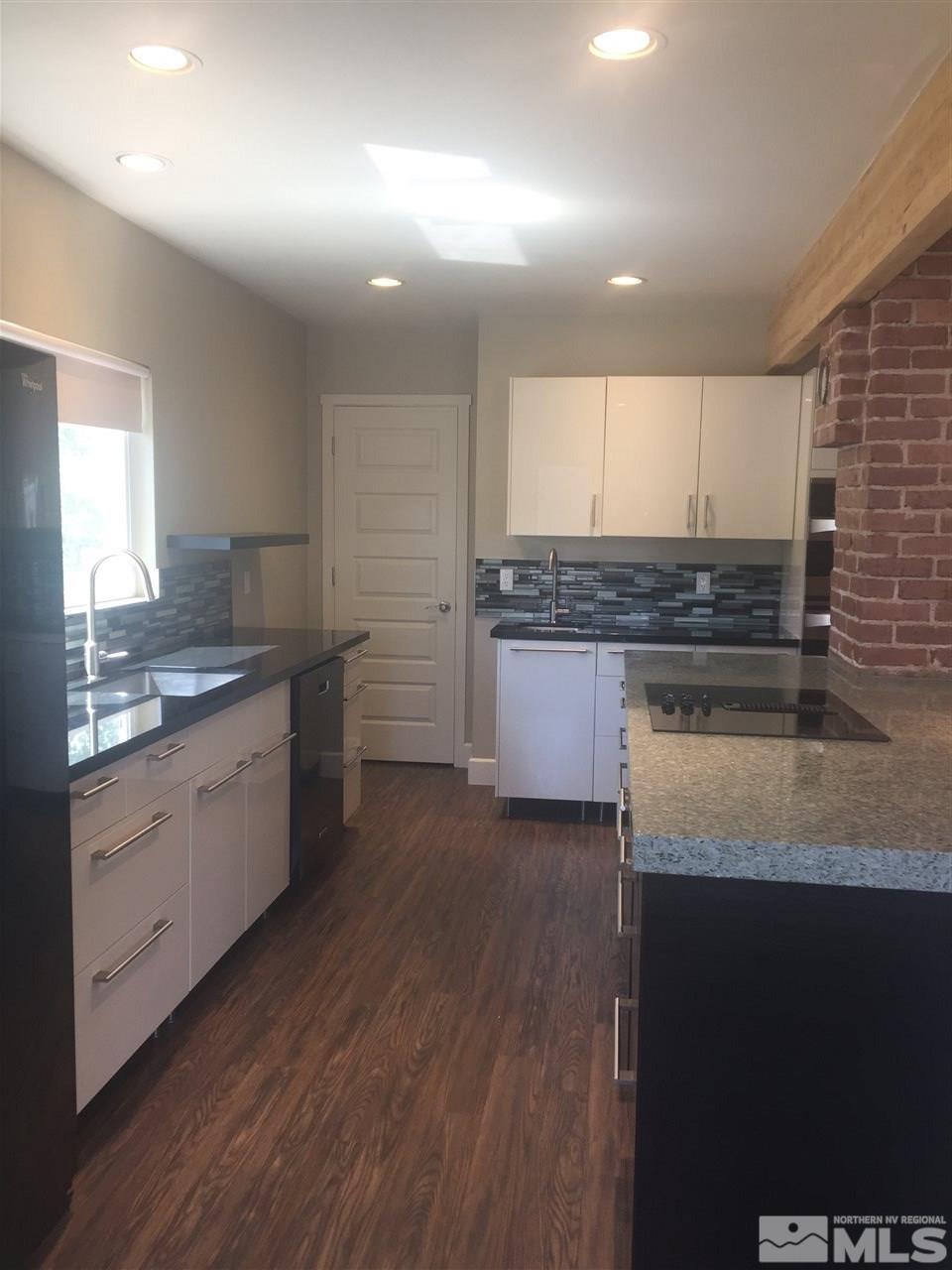 259 West Arroyo Street Reno, NV 89509 - Photo 9 of 24 a kitchen with stainless steel appliances granite countertop wooden cabinets and a granite counter tops