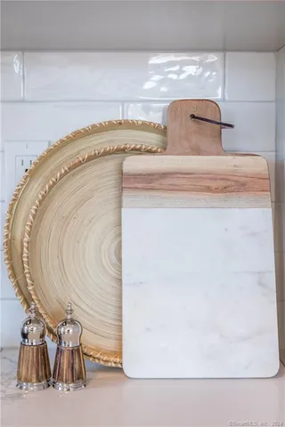 a kitchen with white cabinets appliances a sink and a window
