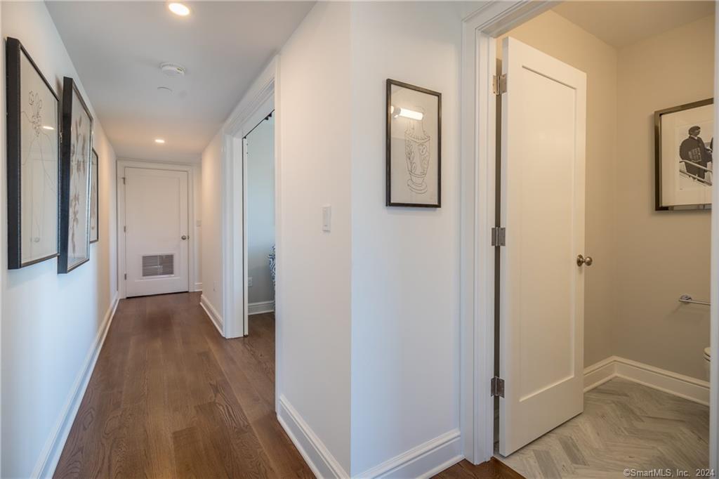 201 Main Street, Unit 203 Westport, CT 06880 - Photo 21 of 40 a view of a hallway with wooden floor and closet