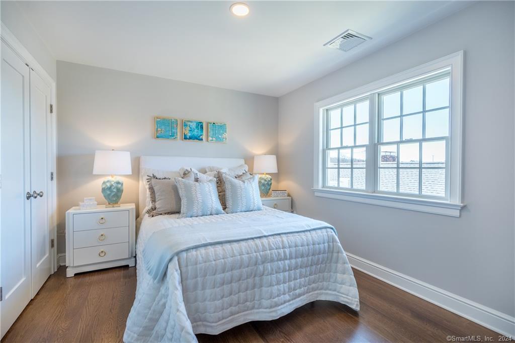 201 Main Street, Unit 203 Westport, CT 06880 - Photo 24 of 40 a bedroom with a bed and a window