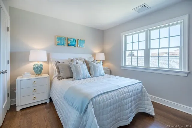 a bathroom with a granite countertop sink toilet and mirror