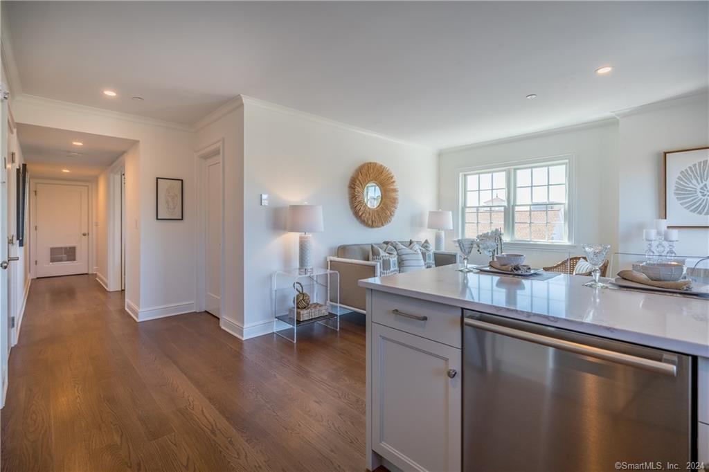 201 Main Street, Unit 203 Westport, CT 06880 - Photo 7 of 40 a open kitchen with sink cabinets and wooden floor