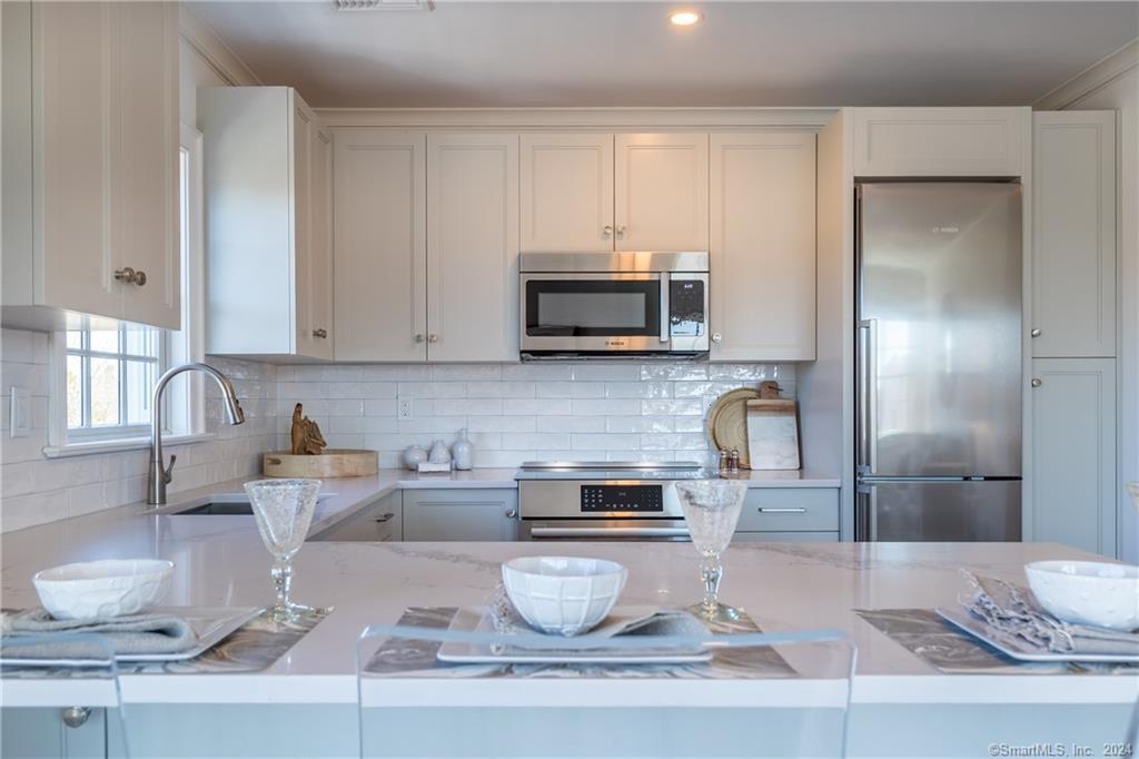 201 Main Street, Unit 203 Westport, CT 06880 - Photo 10 of 40 a kitchen with a sink and a microwave