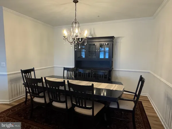 a view of a dining room with furniture and chandelier