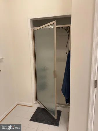 a bathroom with a glass door shower