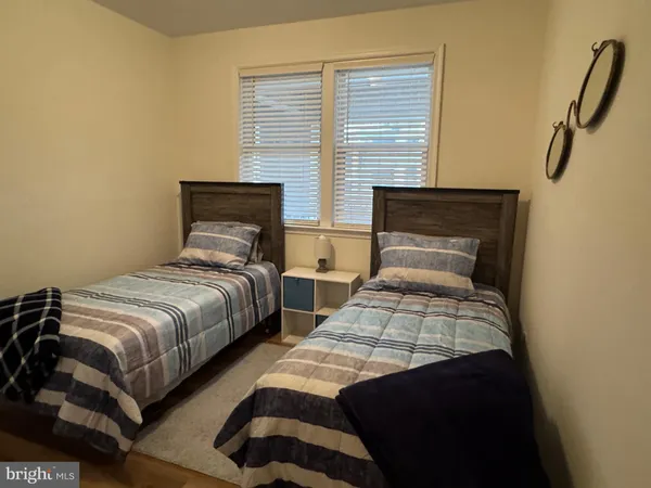 a bedroom with two beds and a window