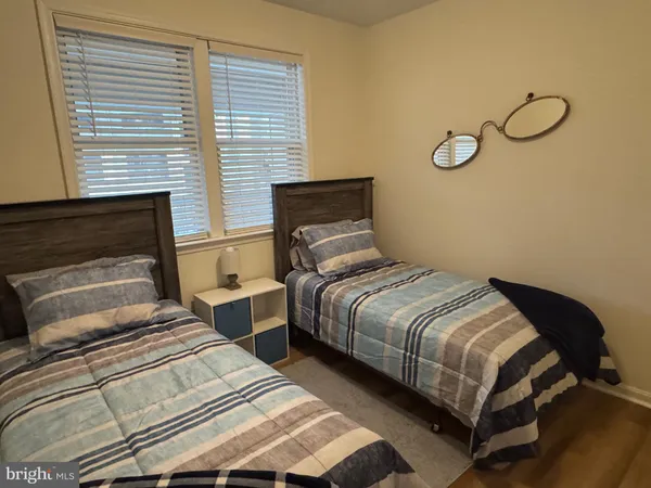 a bedroom with two beds and a window