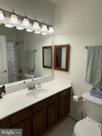 a bathroom with a sink vanity and a mirror