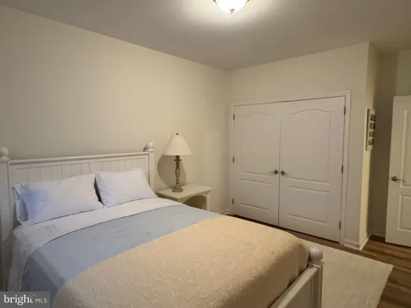 a bedroom with a bed and a night stand