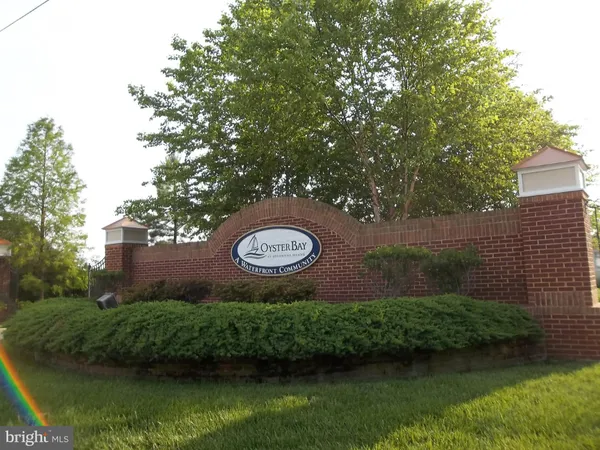 a view of a water pond with green field