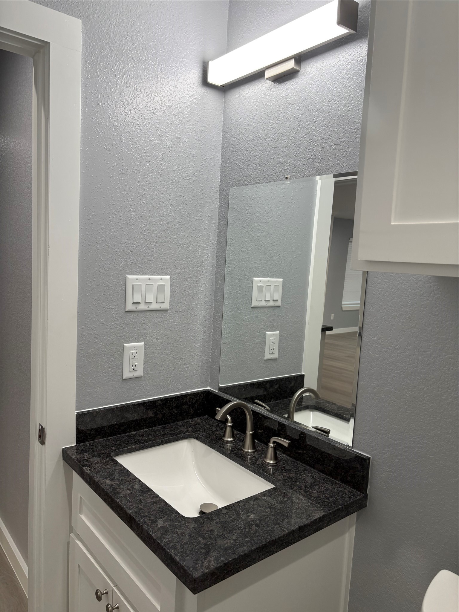 1809 Reese Street Houston, TX 77012 - Photo 16 of 23 a bathroom with a granite countertop sink and a mirror