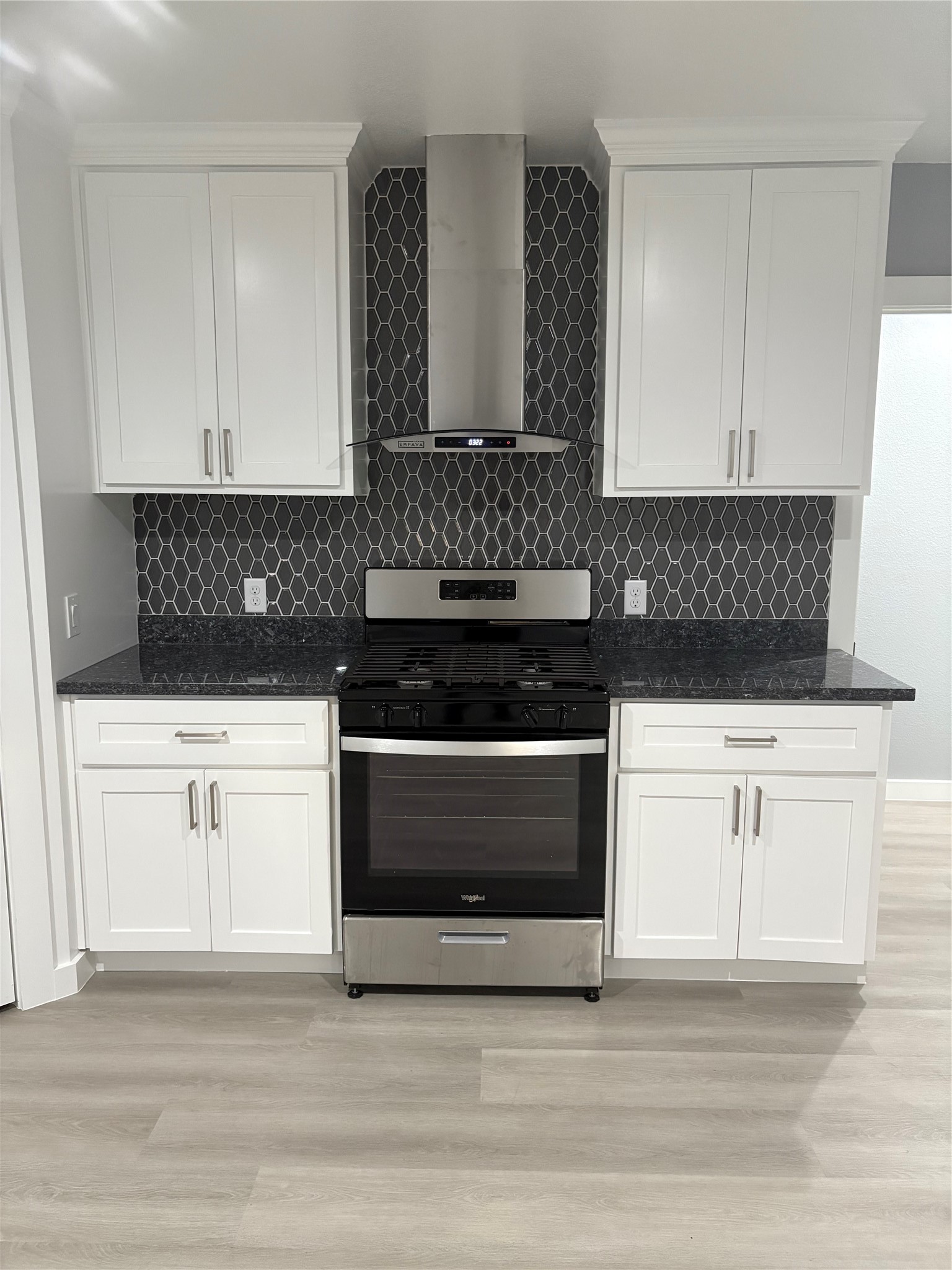 1809 Reese Street Houston, TX 77012 - Photo 5 of 23 a kitchen with granite countertop white cabinets and black appliances