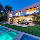 a view of swimming pool with outdoor seating and a garden