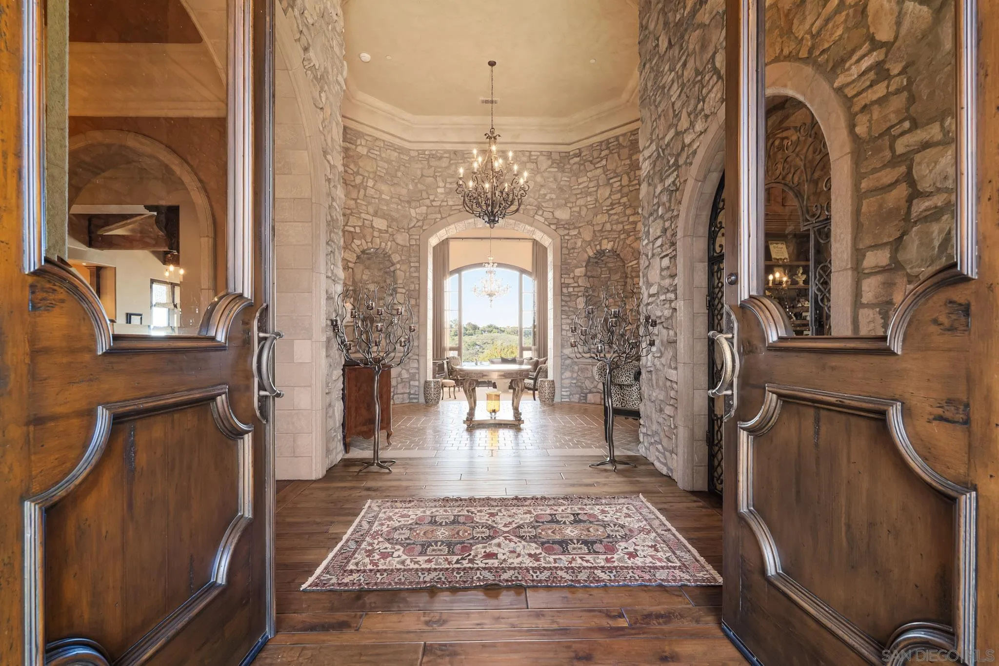 18486 Via Candela Rancho Santa Fe, CA 92091 - Photo 4 of 34 a view of a hallway with a dining table & chairs