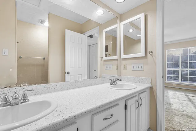 a bathroom with a sink double vanity and a shower