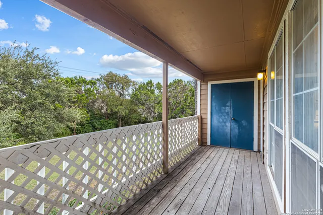 a view of a balcony with wooden floor