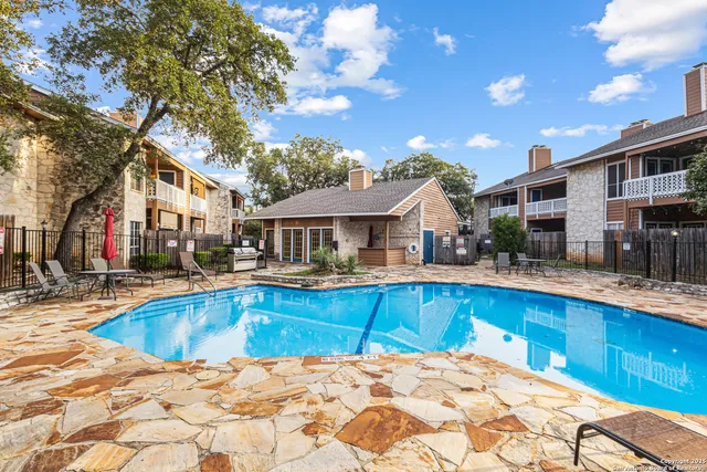 a view of a house with pool and sitting area