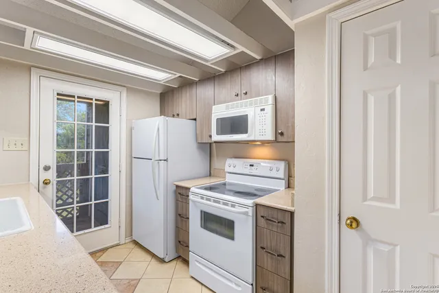 a kitchen with stainless steel appliances a stove a refrigerator and cabinets