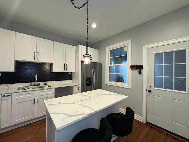 a kitchen with refrigerator cabinets and wooden floor