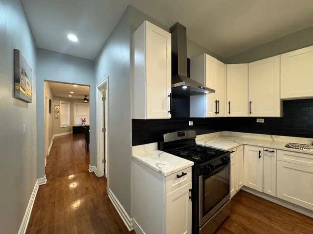 a kitchen with a sink and a stove top oven