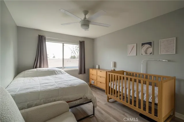 a bedroom with a bed and a large window