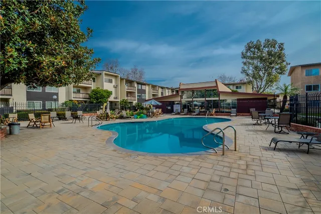 a swimming pool with outdoor seating and yard