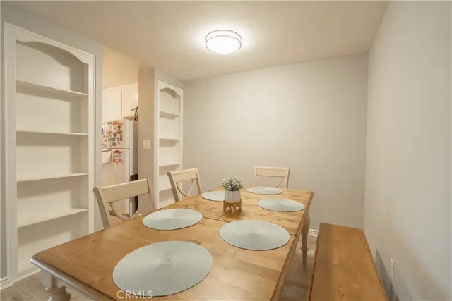 a dining room with furniture and wooden floor