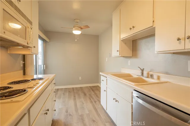 a view of a kitchen counter space a sink and dishwasher