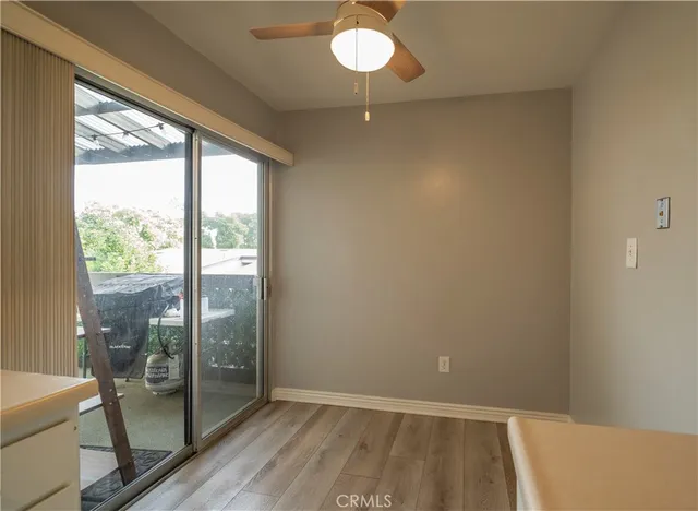 a view of a room with wooden floor and fan