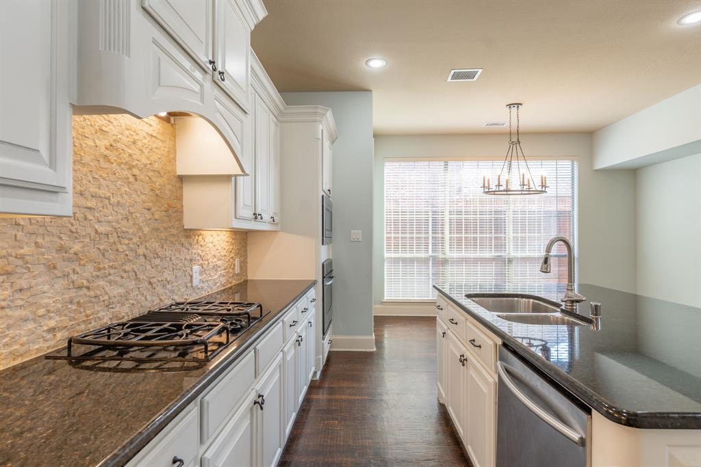 11775 Frontier Drive Frisco, TX 75033 - Photo 11 of 40 a kitchen with a stove a sink and a window