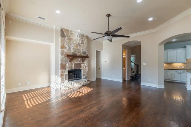 a view of a livingroom with wooden floor and a ceiling fan
