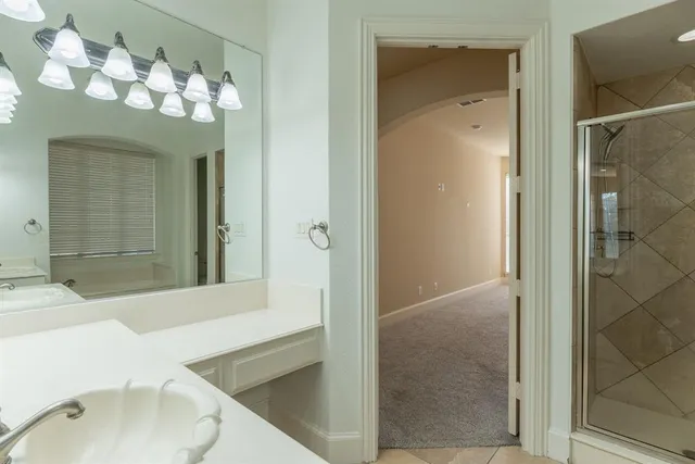 a bathroom with a sink vanity and mirror