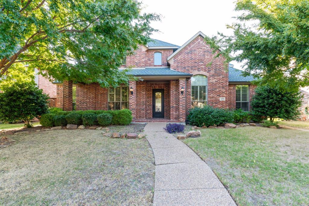 11775 Frontier Drive Frisco, TX 75033 - Photo 2 of 40 a front view of a house with yard and tress