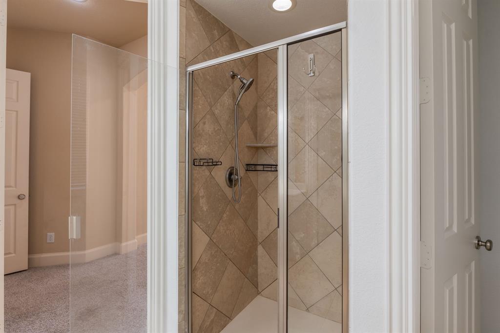 11775 Frontier Drive Frisco, TX 75033 - Photo 21 of 40 a bathroom with a shower and a glass door