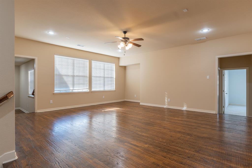11775 Frontier Drive Frisco, TX 75033 - Photo 24 of 40 a view of an empty room with window and wooden floor