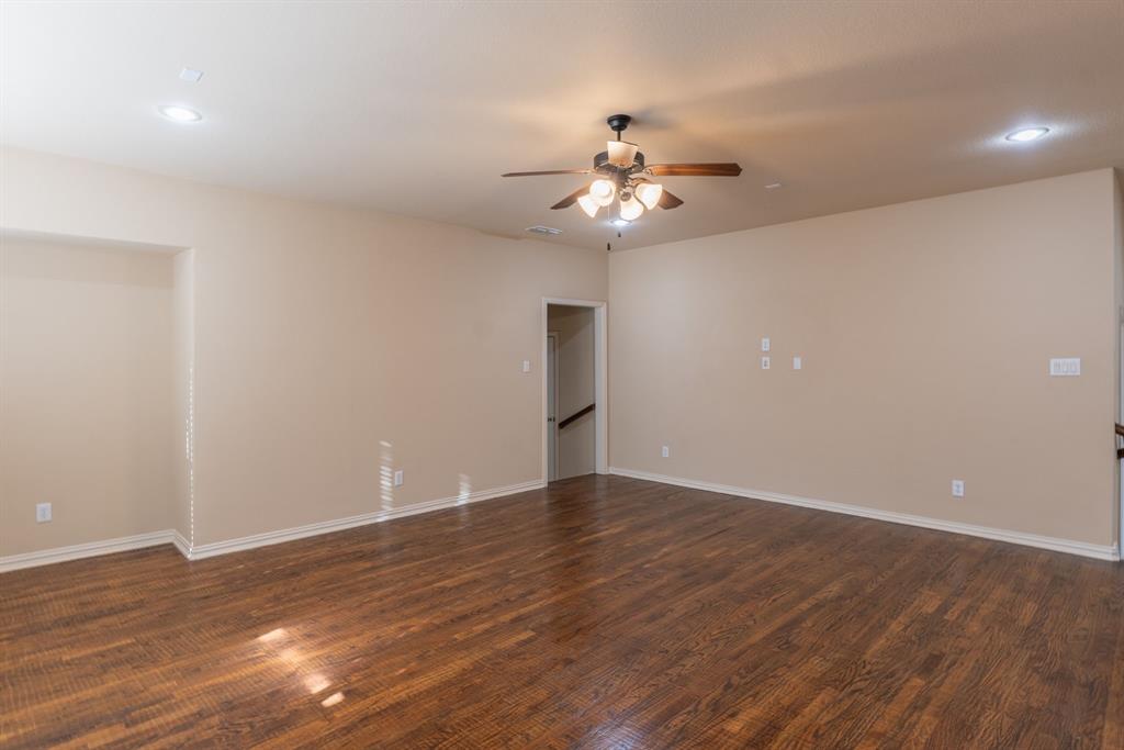 11775 Frontier Drive Frisco, TX 75033 - Photo 25 of 40 a view of an empty room with wooden floor and a ceiling fan