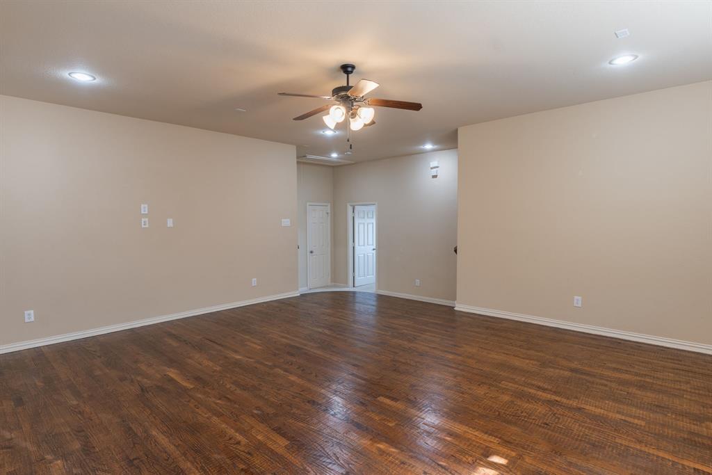 11775 Frontier Drive Frisco, TX 75033 - Photo 26 of 40 an empty room with wooden floor fan and windows