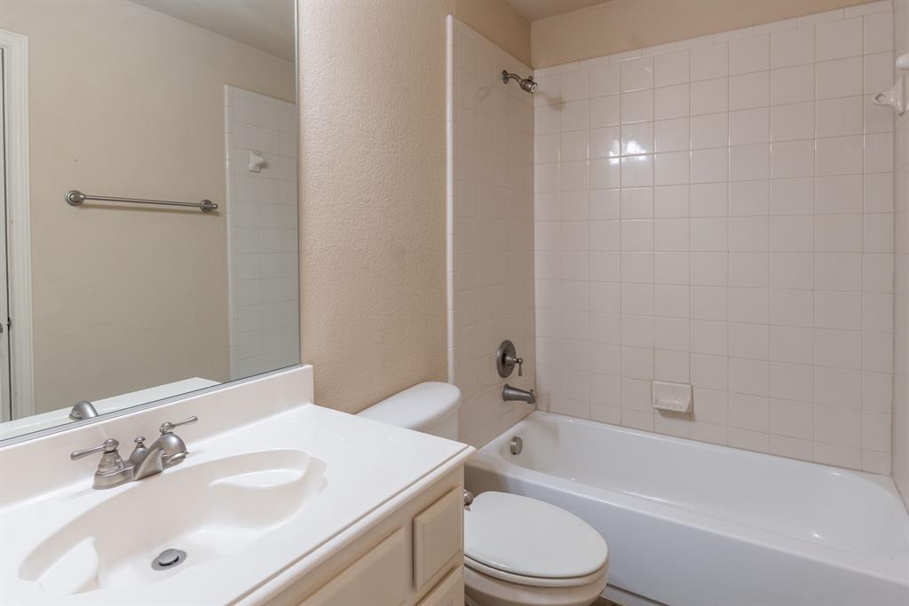 11775 Frontier Drive Frisco, TX 75033 - Photo 28 of 40 a bathroom with a bathtub shower sink vanity mirror and toilet