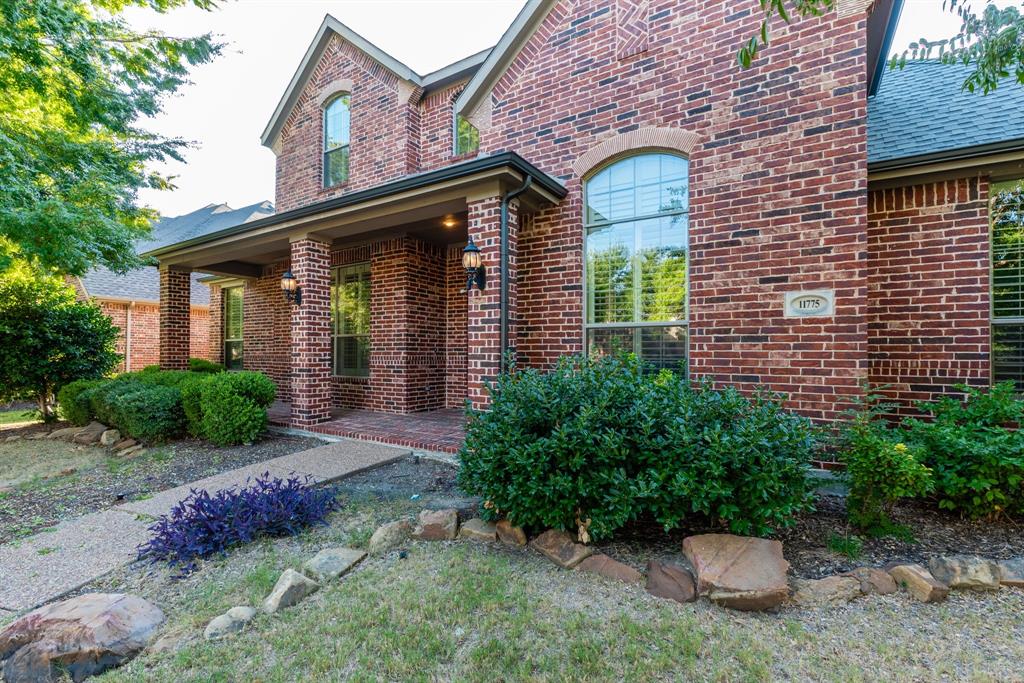 11775 Frontier Drive Frisco, TX 75033 - Photo 3 of 40 a front view of a house with a garden