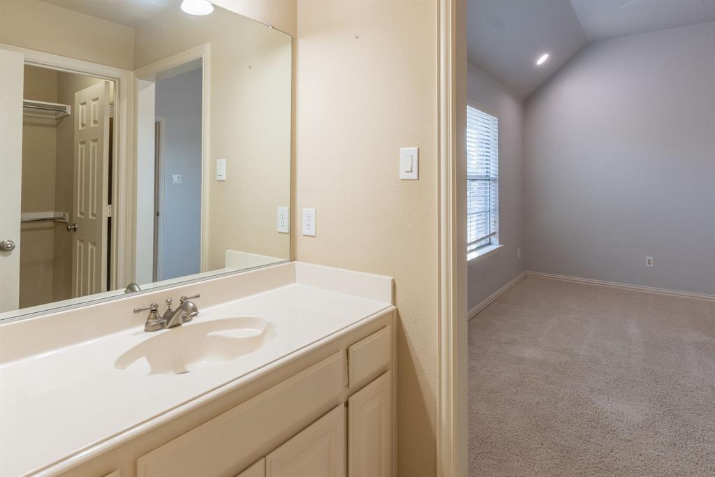 11775 Frontier Drive Frisco, TX 75033 - Photo 31 of 40 a bathroom with a sink and a mirror