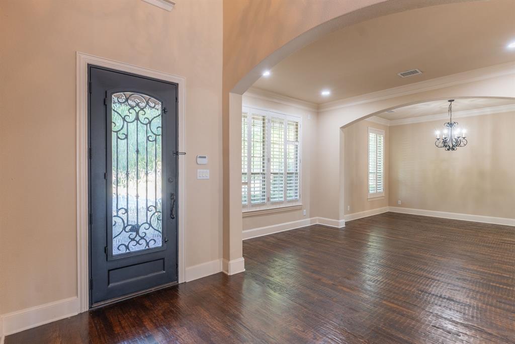 11775 Frontier Drive Frisco, TX 75033 - Photo 5 of 40 a view of an empty room with wooden floor and a window