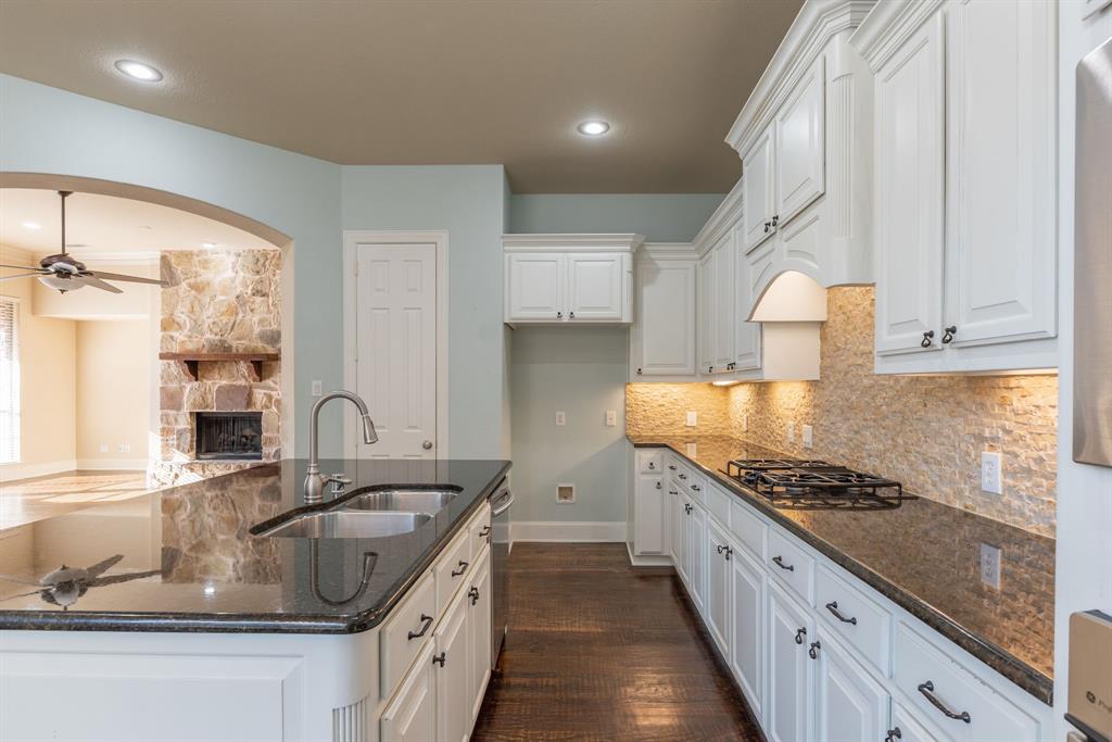11775 Frontier Drive Frisco, TX 75033 - Photo 9 of 40 a kitchen with stainless steel appliances granite countertop a sink stove and cabinets