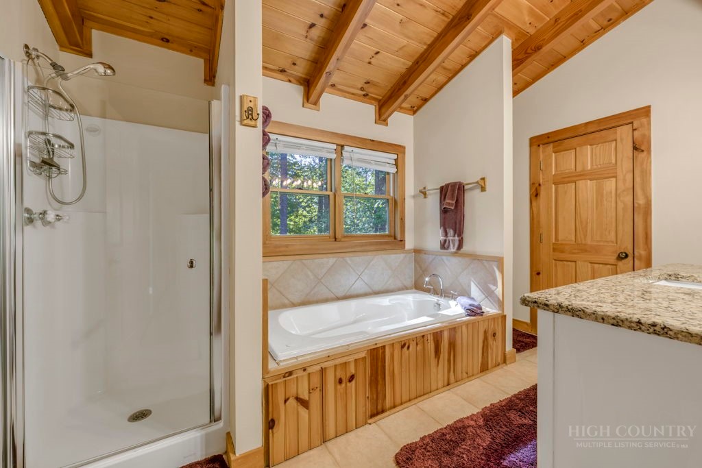 2229 Elk Ridge Road Ferguson, NC 28624 - Photo 30 of 42 a bathroom with a tub a sink and a shower