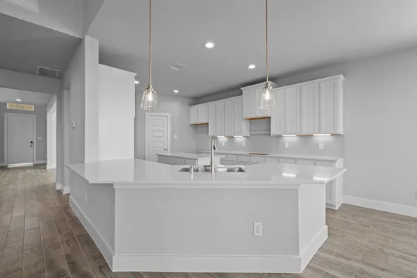 a large kitchen with stainless steel appliances granite countertop a sink a oven and a refrigerator