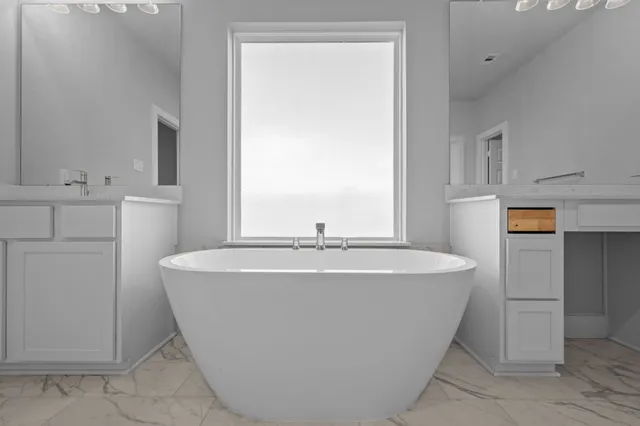 a bathroom with a bathtub and a sink