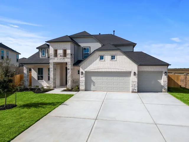 a front view of a house with a yard and potted plants