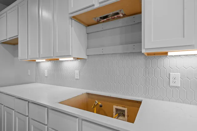 a kitchen with sink cabinets and refrigerator