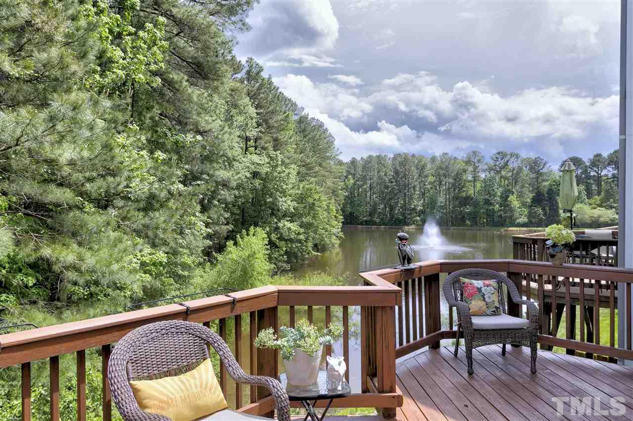 7314 Doverton Court Raleigh, NC 27615 - Photo 1 of 30 a balcony with wooden floor table and chairs